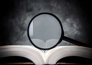 Magnify glass on top of an open book