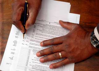 Person filling out forms